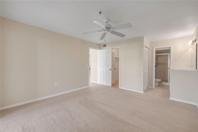407 Bouchelle Dr Unit 205, New Smyrna Beach, FL 32169 - unfurnished bedroom with ceiling fan, a spacious closet, carpet flooring, and baseboards