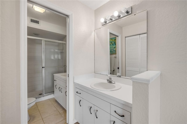 407 Bouchelle Dr Unit 205, New Smyrna Beach, FL 32169 - full bath with visible vents, toilet, a stall shower, vanity, and tile patterned floors