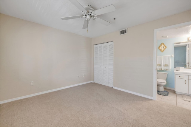 407 Bouchelle Dr Unit 205, New Smyrna Beach, FL 32169 - unfurnished bedroom with a closet, visible vents, light carpet, and baseboards
