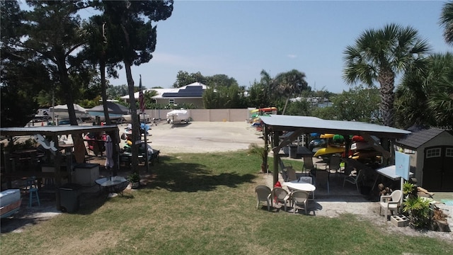 407 Bouchelle Dr Unit 205, New Smyrna Beach, FL 32169 - view of yard with a shed, fence, and an outbuilding
