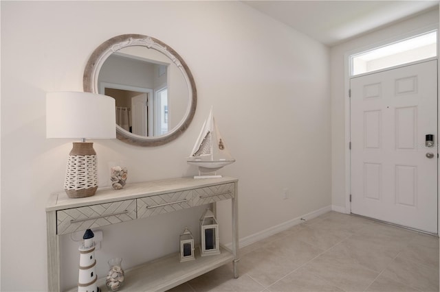 entryway featuring light tile patterned floors and baseboards