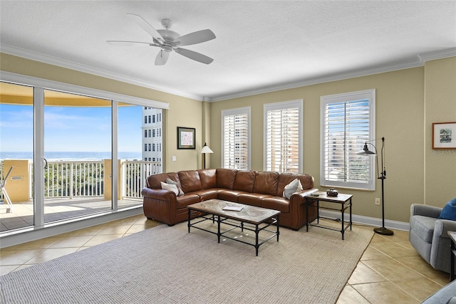 living area with light tile patterned flooring, a healthy amount of sunlight, and ornamental molding