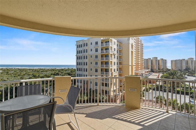 balcony with a water view and a city view