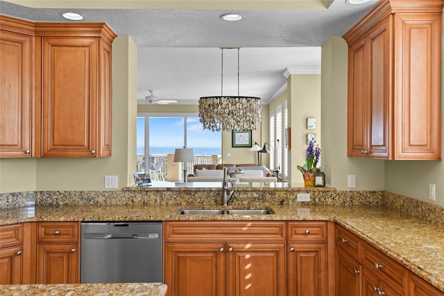 kitchen with light stone counters, a sink, brown cabinets, and stainless steel dishwasher