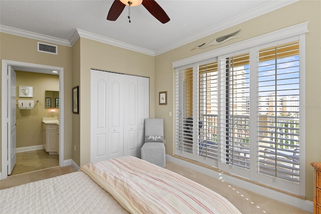 bedroom featuring a ceiling fan, baseboards, visible vents, a closet, and crown molding