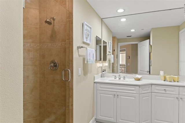 bathroom with recessed lighting, visible vents, vanity, and a shower stall