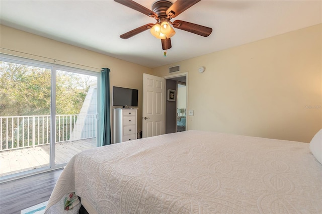 bedroom with access to exterior, a ceiling fan, visible vents, and wood finished floors