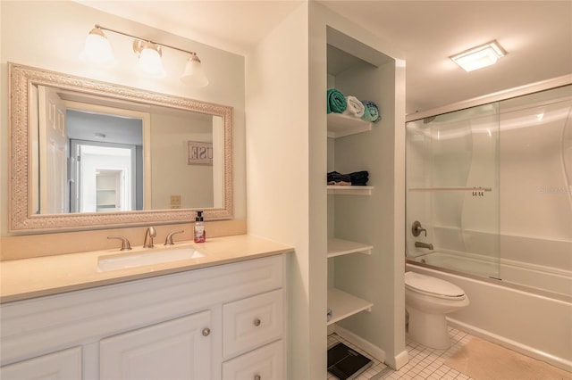 full bathroom featuring tile patterned flooring, vanity, toilet, and bath / shower combo with glass door