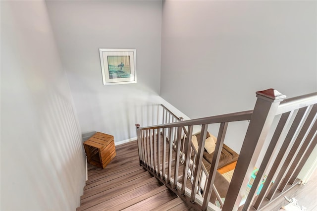 stairs featuring baseboards and wood finished floors