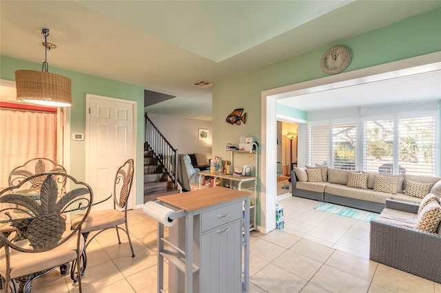 kitchen with open floor plan, visible vents, baseboards, and light tile patterned flooring