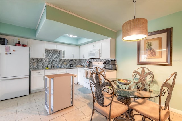 kitchen with white appliances, a sink, white cabinetry, and tasteful backsplash