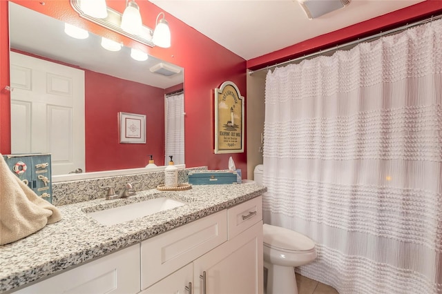 bathroom with tile patterned flooring, a shower with curtain, vanity, and toilet