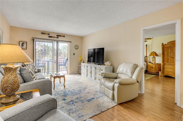 living area featuring a textured ceiling and light wood-type flooring