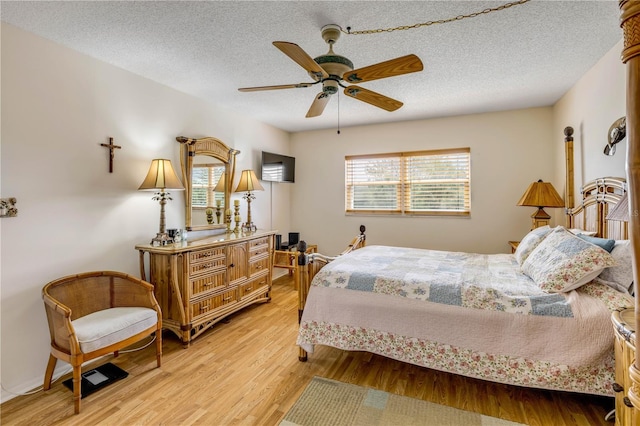 bedroom featuring a textured ceiling and light wood-style floors