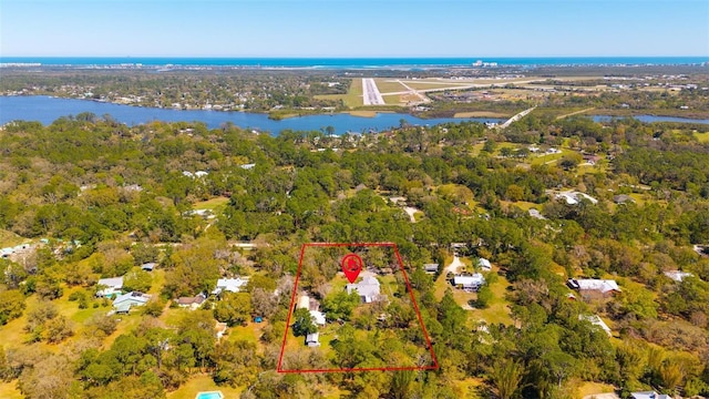 aerial view featuring a view of trees and a water view