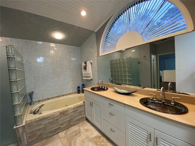 bathroom featuring a shower stall, a tub with jets, double vanity, and a sink