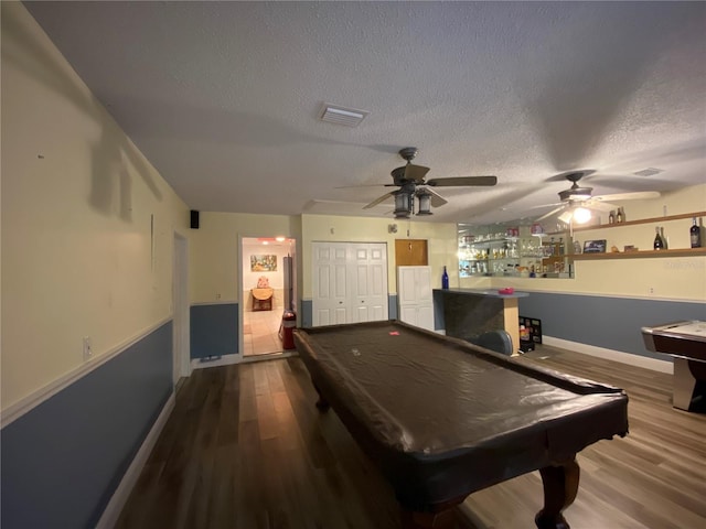 game room with visible vents, a textured ceiling, billiards, a ceiling fan, and dark wood-style flooring