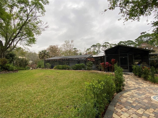 view of yard featuring glass enclosure