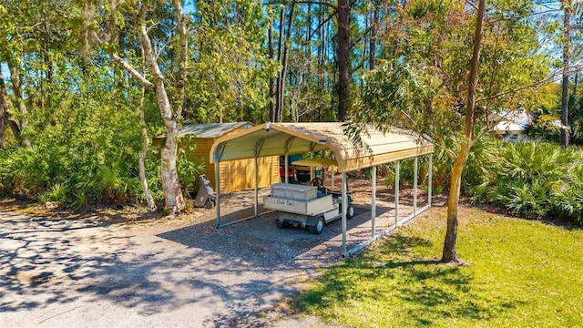 view of parking / parking lot with a detached carport and driveway