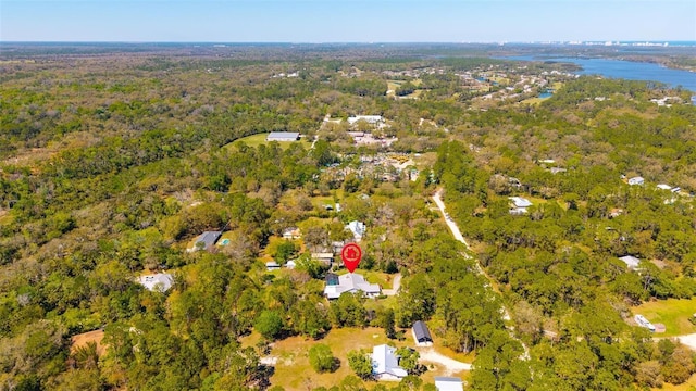 birds eye view of property with a forest view