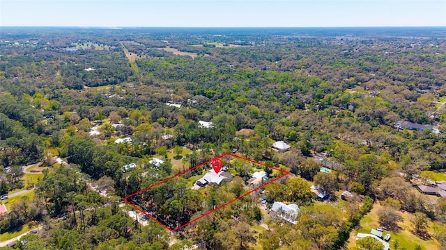 birds eye view of property with a forest view