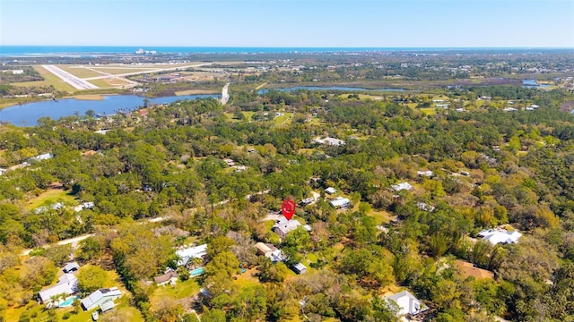 aerial view featuring a water view and a view of trees