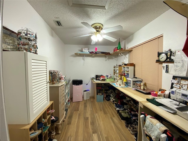 storage featuring visible vents and a ceiling fan