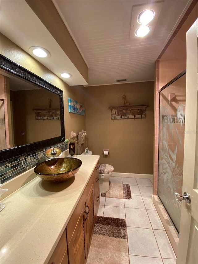 bathroom featuring visible vents, toilet, a shower stall, tile patterned flooring, and vanity