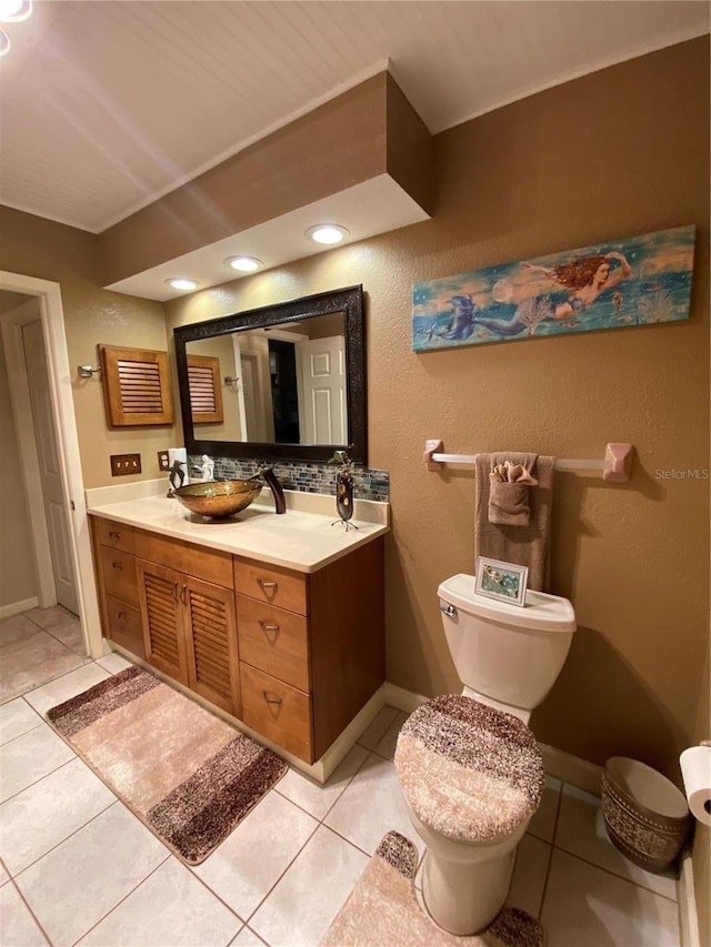 bathroom featuring tile patterned flooring, toilet, and a sink