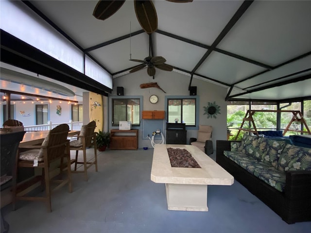 living room with finished concrete floors, lofted ceiling, and ceiling fan