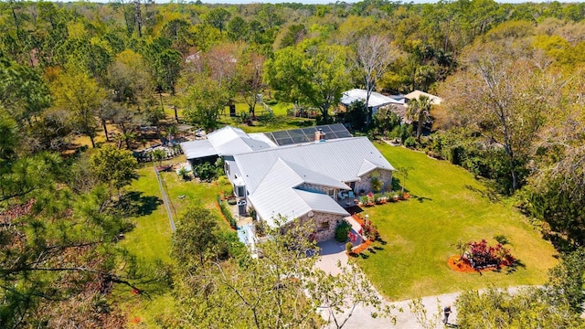 drone / aerial view with a wooded view