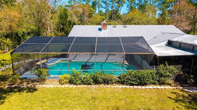 pool with a lanai, a lawn, and a patio