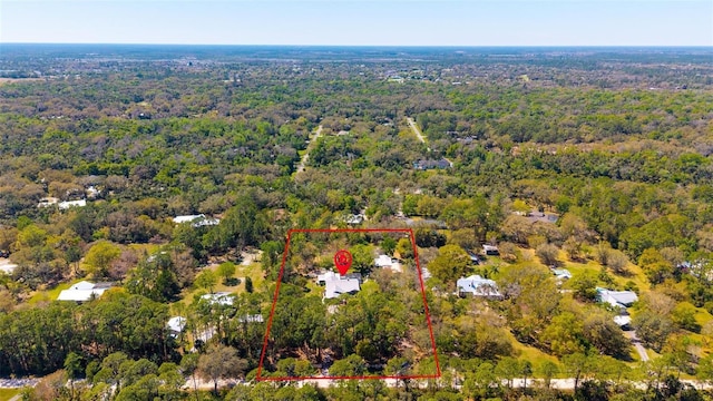 drone / aerial view featuring a forest view