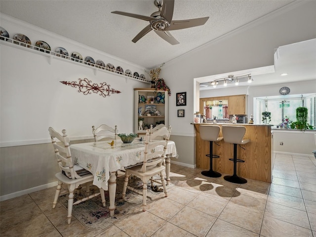 1370 Jane Lacey Ln, New Smyrna Beach, FL 32168 - dining space with a textured ceiling, light tile patterned floors, ceiling fan, and ornamental molding