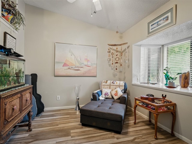 1370 Jane Lacey Ln, New Smyrna Beach, FL 32168 - living area with wood finished floors, a textured ceiling, baseboards, and a ceiling fan
