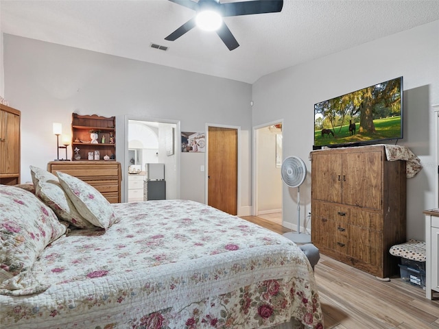 1370 Jane Lacey Ln, New Smyrna Beach, FL 32168 - bedroom with light wood finished floors, ceiling fan, and connected bathroom