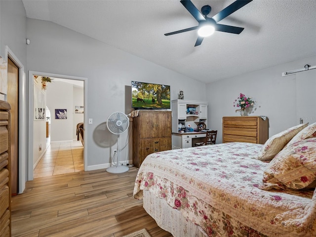 1370 Jane Lacey Ln, New Smyrna Beach, FL 32168 - bedroom with vaulted ceiling, light wood finished floors, a textured ceiling, and a ceiling fan