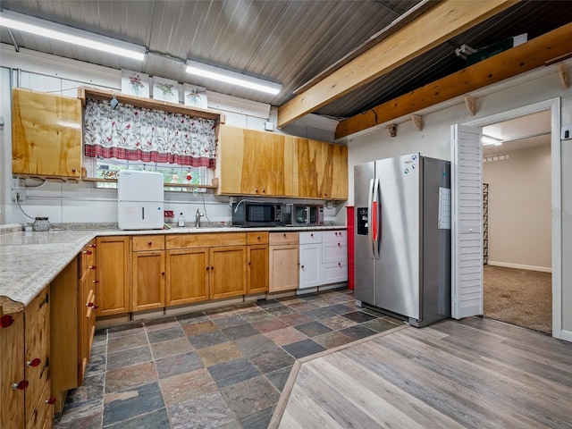 1370 Jane Lacey Ln, New Smyrna Beach, FL 32168 - kitchen with stainless steel fridge with ice dispenser, black microwave, a sink, light countertops, and brown cabinetry