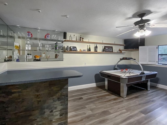 1370 Jane Lacey Ln, New Smyrna Beach, FL 32168 - indoor dry bar featuring a ceiling fan, wood finished floors, baseboards, and a textured ceiling