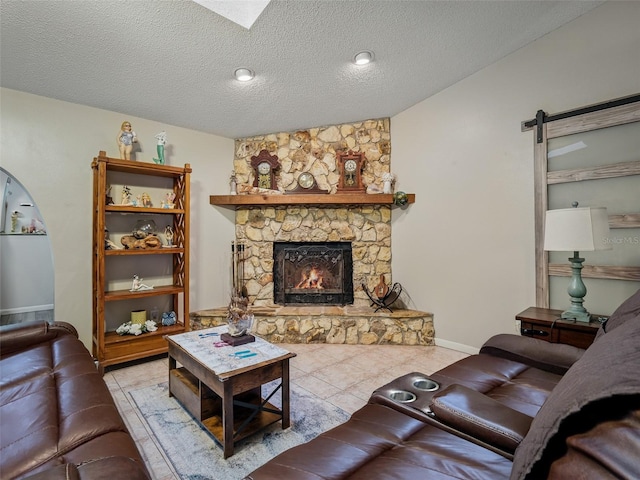 1370 Jane Lacey Ln, New Smyrna Beach, FL 32168 - living area featuring a fireplace, tile patterned flooring, a textured ceiling, and baseboards