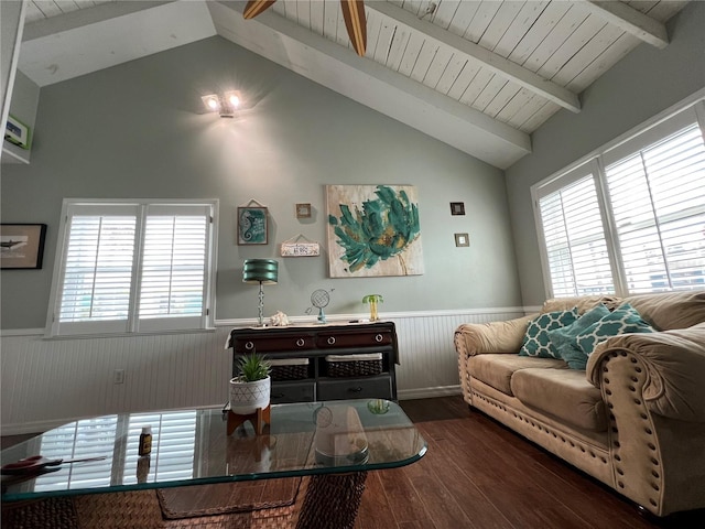 living area featuring a wealth of natural light, a wainscoted wall, lofted ceiling with beams, and wood finished floors