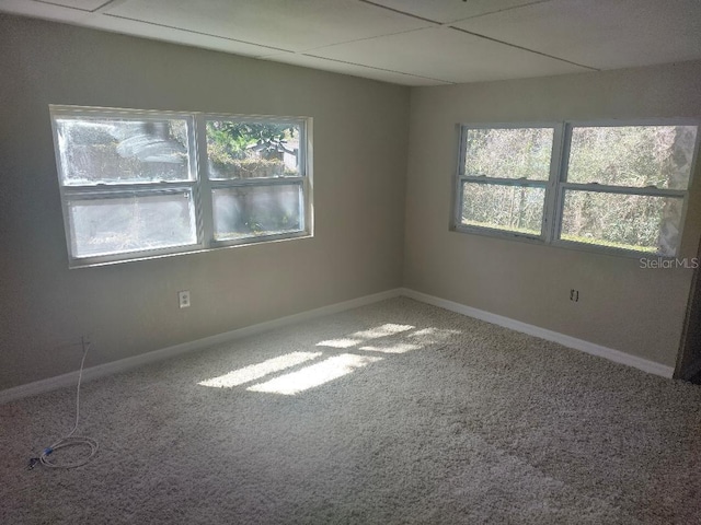 unfurnished room featuring carpet floors and baseboards