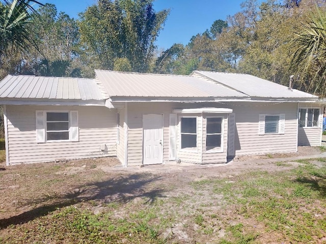 ranch-style home with metal roof