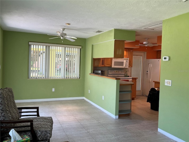 630 Yupon Ave, New Smyrna Beach, FL 32169 - kitchen featuring white appliances, baseboards, visible vents, and ceiling fan