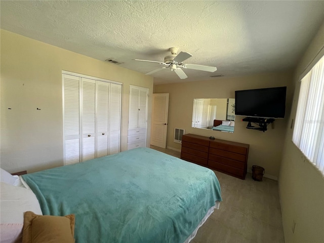 630 Yupon Ave, New Smyrna Beach, FL 32169 - bedroom featuring a ceiling fan, a textured ceiling, visible vents, and multiple closets