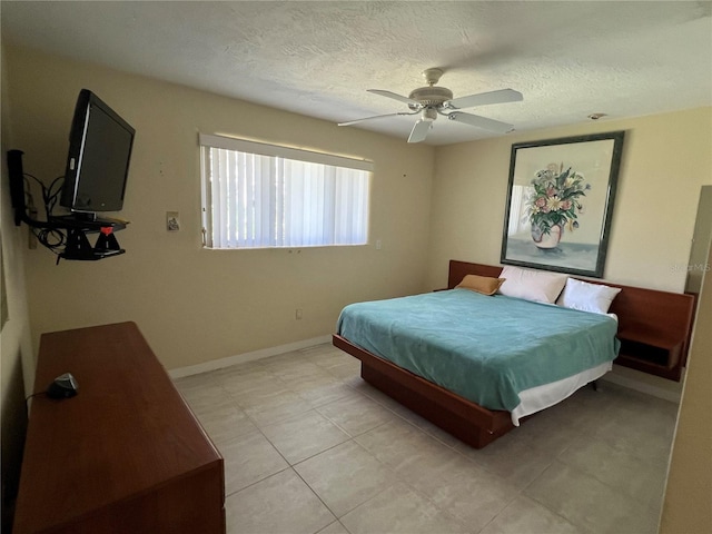 630 Yupon Ave, New Smyrna Beach, FL 32169 - bedroom with a textured ceiling, a ceiling fan, and baseboards