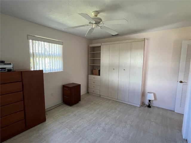 630 Yupon Ave, New Smyrna Beach, FL 32169 - bedroom featuring a textured ceiling, a closet, and a ceiling fan