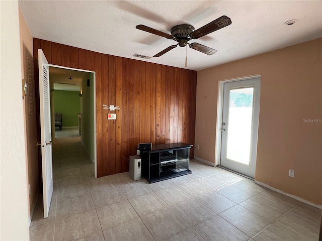 630 Yupon Ave, New Smyrna Beach, FL 32169 - interior space with a textured ceiling, a ceiling fan, visible vents, and wooden walls