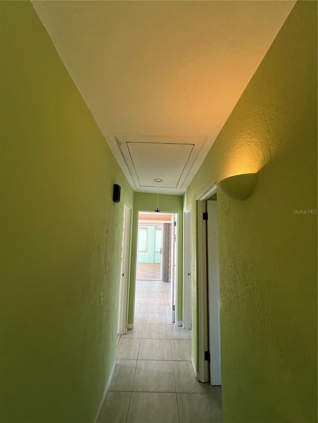 630 Yupon Ave, New Smyrna Beach, FL 32169 - hall featuring attic access, light tile patterned flooring, and a textured wall
