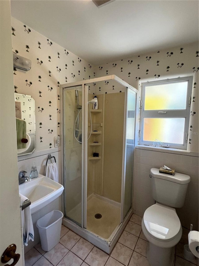 630 Yupon Ave, New Smyrna Beach, FL 32169 - bathroom featuring a shower stall, tile patterned flooring, tile walls, and wallpapered walls